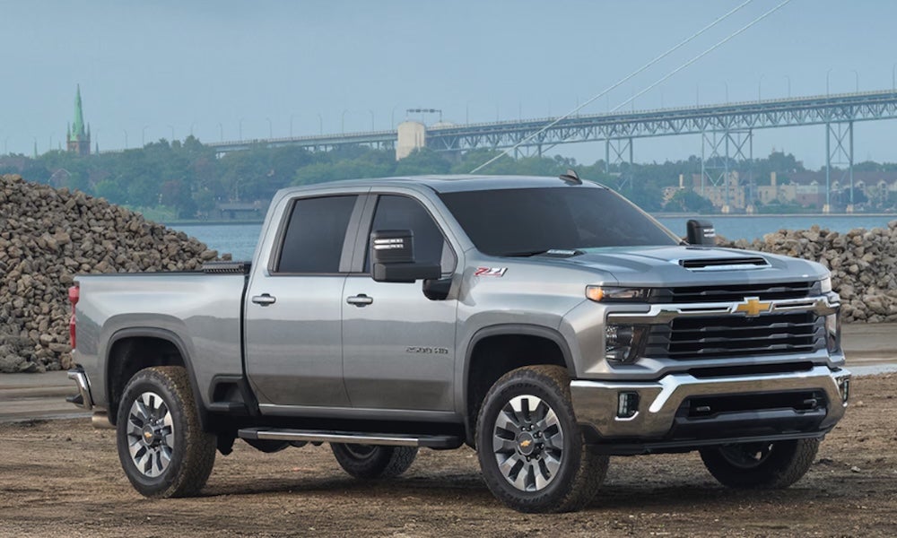  A silver 2026 Chevrolet Silverado 2500 HD truck parked beside a river